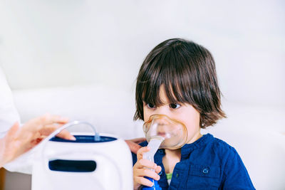 Cute girl wearing oxygen mask in hospital