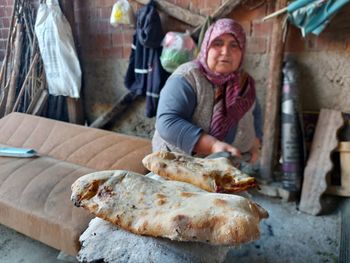 Young man preparing food at market stall