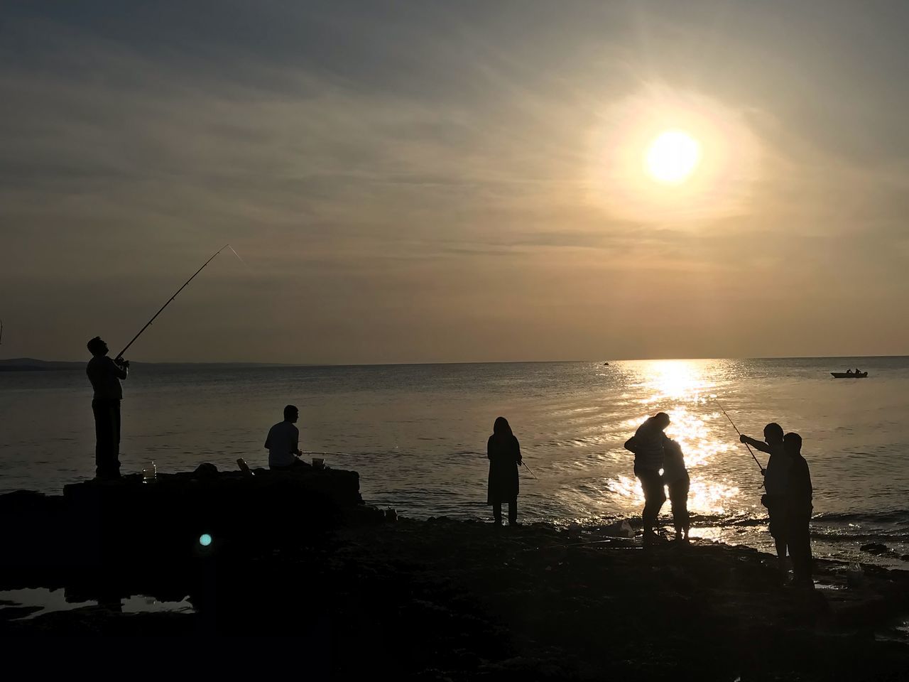 SILHOUETTE PEOPLE ON BEACH AT SUNSET