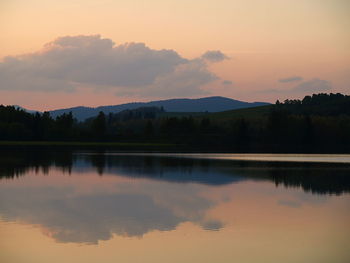 Scenic view of lake against romantic sky at sunset