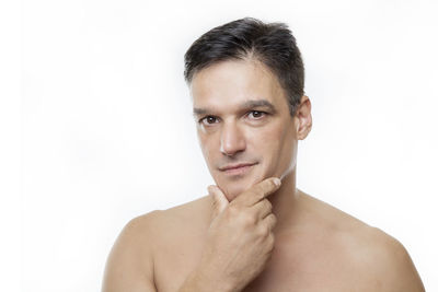 Portrait of shirtless man against white background