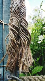 Close-up of rope tied against sky