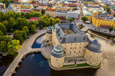 High angle view of buildings and trees in city