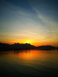 Scenic view of lake against romantic sky at sunset