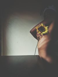 Close-up of woman wearing flower at home