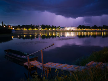 Scenic view of lake against sky at night