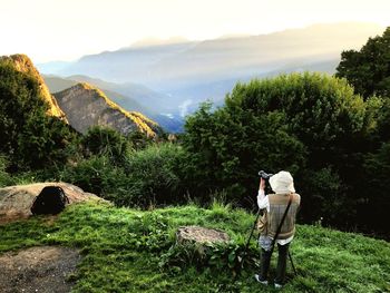 Rear view of man standing on mountain