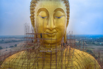 Statue of buddha against building