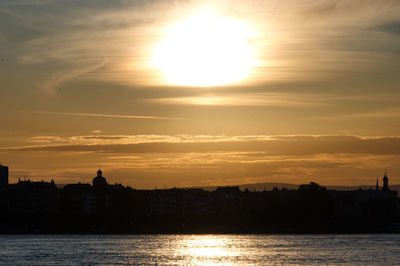 Silhouette buildings against sky during sunset