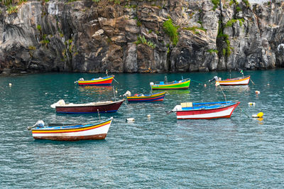 Boats moored on sea shore