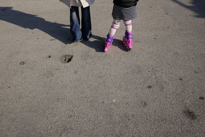 Low section of girl balancing on roller skate 