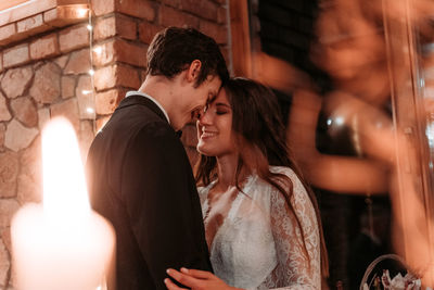 Newlywed couple with face to face standing outdoors