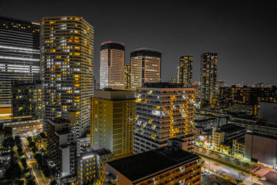 Low angle view of illuminated buildings against sky at night