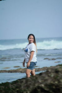 Full length of boy on beach against sky