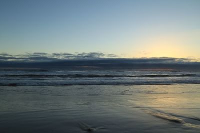 View of calm beach at sunset