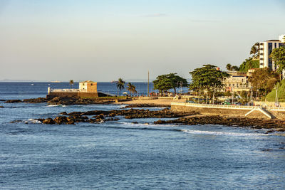 Seafront of the city of salvador in bahia with its buildings and the old fort of santa maria