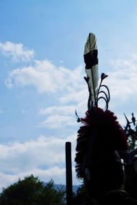 Low angle view of sculpture against cloudy sky