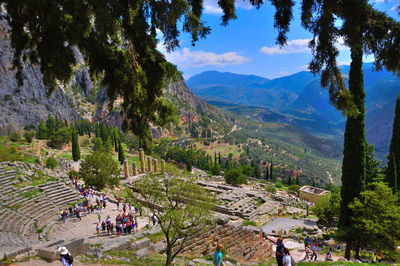 People on mountain against sky