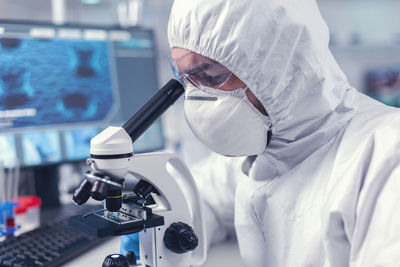 Midsection of doctor examining patient in laboratory