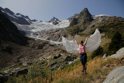 Man standing on mountain against sky