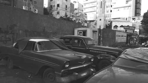 Cars on street amidst buildings in city