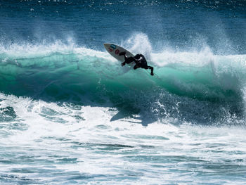 People surfing in sea