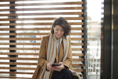 Smiling businesswoman using cell phone