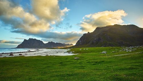 View of calm countryside lake against rocky mountains