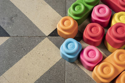 High angle view of multi colored toys on tiled floor