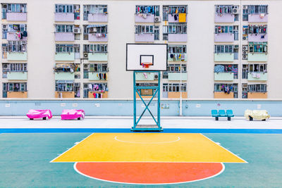 Low angle view of basketball hoop against building in city