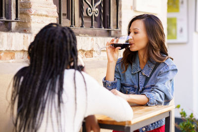 Female friends enjoying wine at cafe