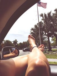 Low section of man skateboarding on car