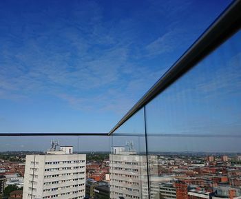 Buildings in city against blue sky