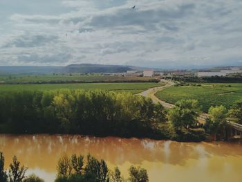 Scenic view of field against cloudy sky