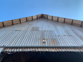 Low angle view of building against clear blue sky