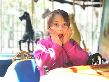Portrait of shocked girl at amusement park