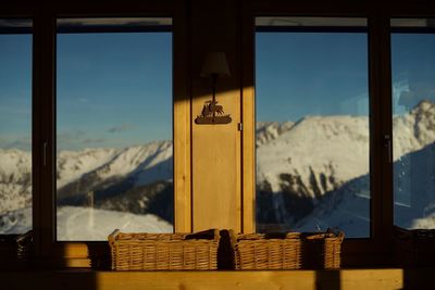 Scenic view of snowcapped mountains seen through window