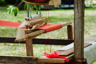 Close-up of red tied up on wooden table