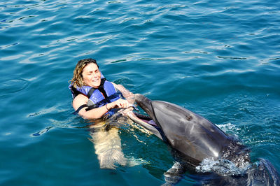 Picture of a dolphin playing with lady 