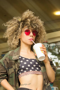 Midsection of woman drinking coffee