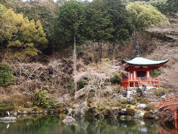 Built structure by lake and trees in forest