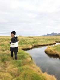 Full length of woman on green field