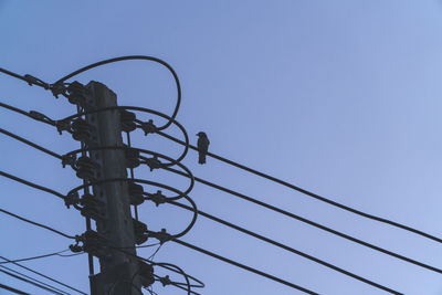 Low angle view of electricity pylon against sky