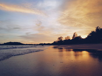 Scenic view of beach against sky during sunset