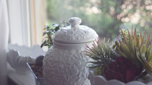 Close-up of white sculpture on table at home