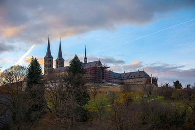 View of cityscape against cloudy sky