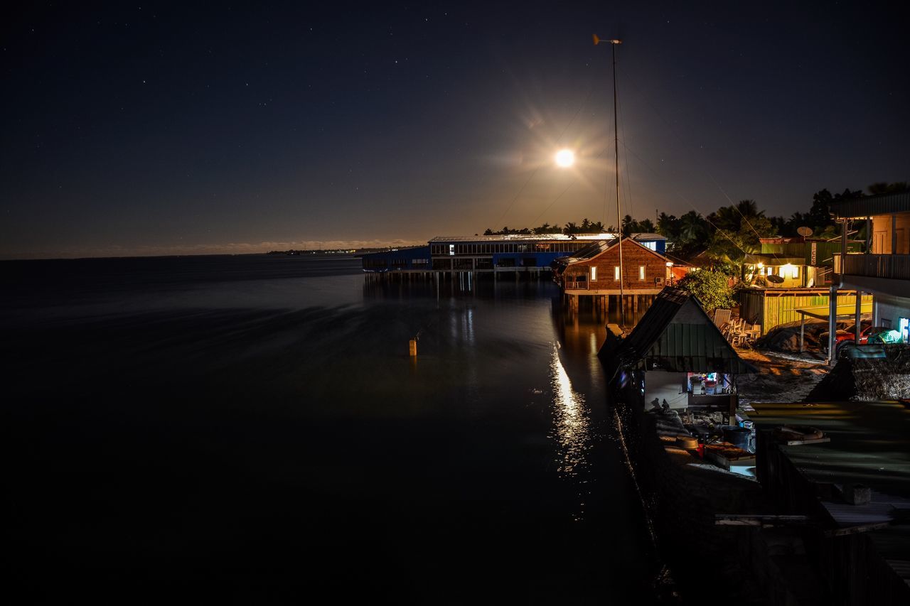 night, water, illuminated, nautical vessel, transportation, boat, reflection, tranquil scene, mode of transport, tranquility, moored, scenics, sea, sky, moon, waterfront, calm, outdoors, nature, beauty in nature, dark, sun, moonlight
