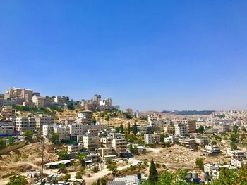 Aerial view of buildings against clear blue sky