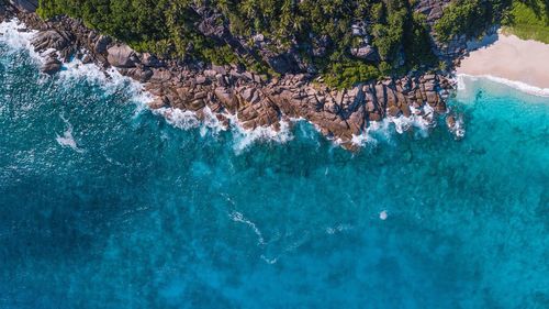 Aerial view of sea by mountain 