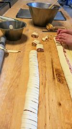 High angle view of hand holding bowl on table